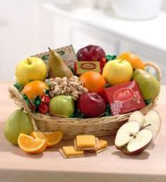 a basket filled with lots of different types of fruit and snacks on top of a table