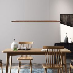 a wooden table with two chairs and a vase on it