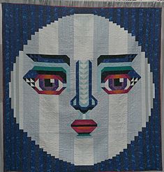 a woman's face is depicted on a quilt