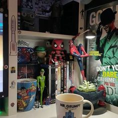 a coffee cup sitting on top of a desk next to a book shelf filled with books