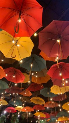 many colorful umbrellas are hanging from the ceiling