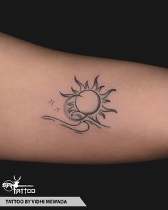 a sun and moon tattoo on the arm