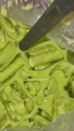 the green liquid is being poured onto the food