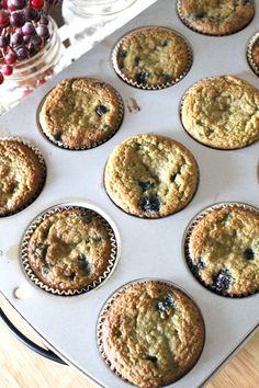 a muffin tin filled with blueberry muffins