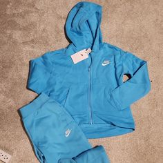 Nike Nwt Sweat Suit. Hoodie Has A Zipper, 2 Front Pockets And Is Slightly Raised In The Front And Lower On The Back. Has A Matching Pant With Pockets And Cuffed Ankles. Super Cozy And Warm, Never Worn. Nike Sweat Suit, Gifts For Myself, Girl Sweat, Sweat Suit, Kids Nike, Nike Blue, Stuff I Want, Matching Sets, Kids Shop