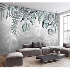 a living room filled with furniture and a large wall mural