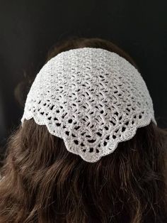 a woman wearing a white crochet headband