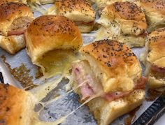 ham and cheese sliders on a baking sheet with melted pepper sprinkles