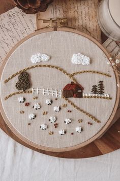 a wooden table topped with an embroidery hoop