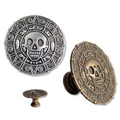 a metal button with a skull on it and an ornate design in the center is shown