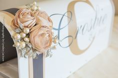 a close up of a mailbox decorated with flowers and pearls