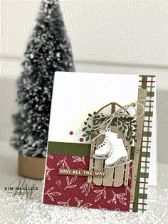 a christmas card with an ice skater on it and a tree in the background