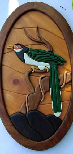 a bird painted on the side of a wooden plaque