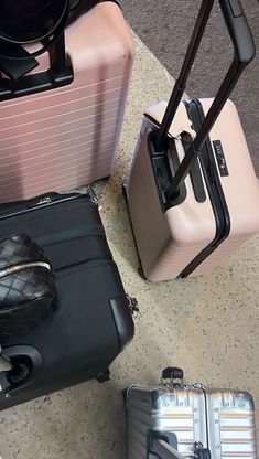 three pieces of luggage sitting next to each other on top of a cement flooring area