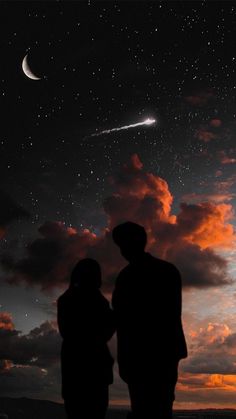 two people looking at the stars in the night sky, with one person standing next to them