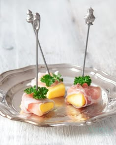 small appetizers with meat and vegetables on a silver plate