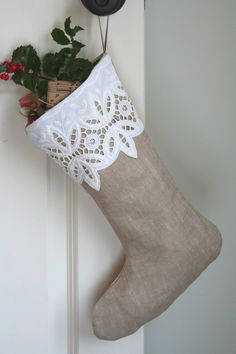 a christmas stocking hanging on a door with a clock and potted plant in the background