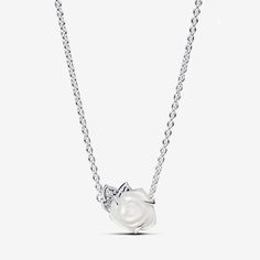 Embrace timeless elegance with our White Rose in Bloom Collier Necklace, a versatile sterling silver flower pendant necklace that goes with everything. A white bioresin man-made mother of pearl, delicately prong-set, unfolds into a blooming rose, symbolizing purity and love. The back side of the rose features two leaves, asymmetrically placed, which reveal subtle cut-outs and are embellished with brilliant cubic zirconia. Adjustable to 42 cm and 38 cm, this symbolic necklace echoes the cherished White Rose Necklace, Pandora White, Collar Rosa, Custom Charm Bracelet, Heart Promise Rings, Rose Hat, Symbol Necklace, Gold Armband, Diamond Gift