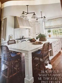 an open magazine showing a kitchen and dining room