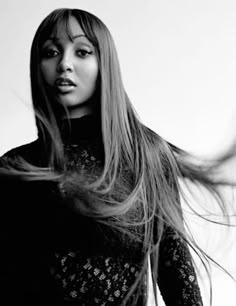 a black and white photo of a woman with long hair