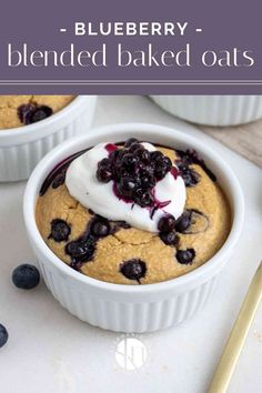 blueberry baked oatmeal in a white bowl with whipped cream on top