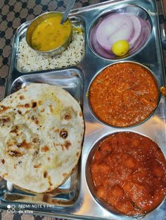 a metal tray filled with different types of food