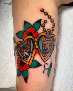 a couple of dogs with heart shaped frames on their legs, tattoo by the owner