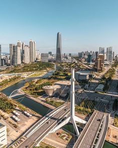 an aerial view of a city with lots of tall buildings and roads in the foreground