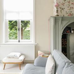 a living room filled with furniture next to a window