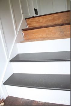 some black and white stairs with wood handrails