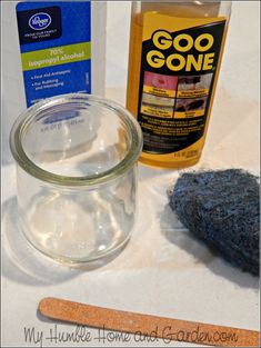 the contents of a glass jar sitting on top of a table next to a wooden spoon