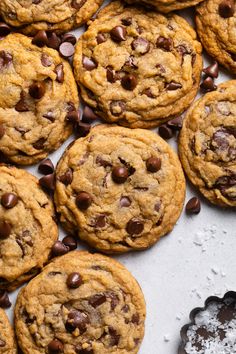 chocolate chip cookies and chocolate chips on a baking sheet