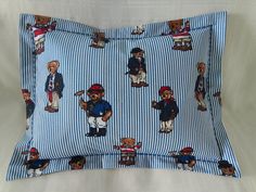 a blue and white striped pillow with bears on it