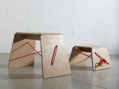 two wooden stools with red string on them