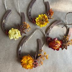 four pairs of scissors with flowers attached to them