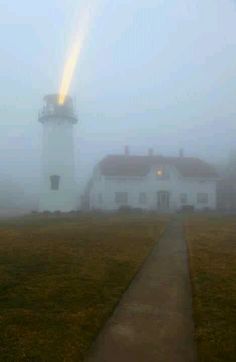 a foggy path leading to a light house