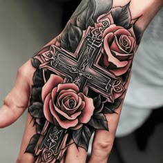 a hand with a cross and roses on it