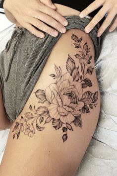 a woman's thigh with flowers on it