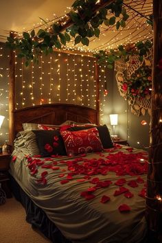 a bed with rose petals on it in a bedroom decorated for valentine's day