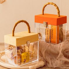 an orange and yellow box sitting on top of a wooden table next to a bag