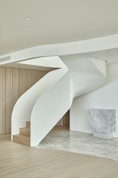 a white spiral staircase in the middle of a room