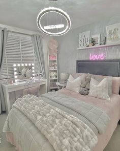 a bedroom decorated in pink and grey with white bedding