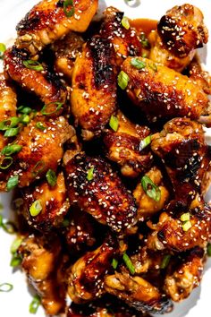 chicken wings with sesame seeds and seasoning on a white plate