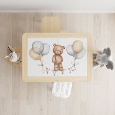 an overhead view of a baby's room with teddy bears and balloons