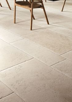 a dining room table and chairs on a tile floor