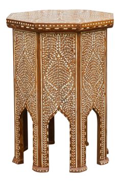 an intricately carved wooden side table