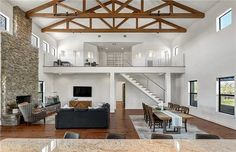 a large open floor plan living room with high ceilings