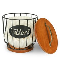 a cake in a basket with a wooden lid and the word futters on it