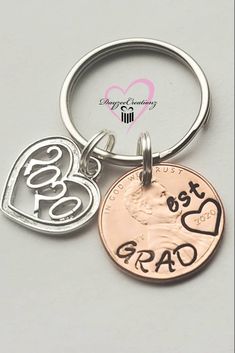 two heart shaped charms with the word best dad on one side and an i love you coin on the other