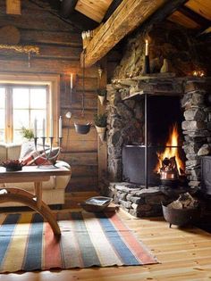 a living room filled with furniture and a fire place in the middle of a room